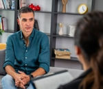 Man in a blue shirt talking with his therapist during a counselling session in Vaughan