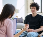 Therapist in conversation with a student in a bright office