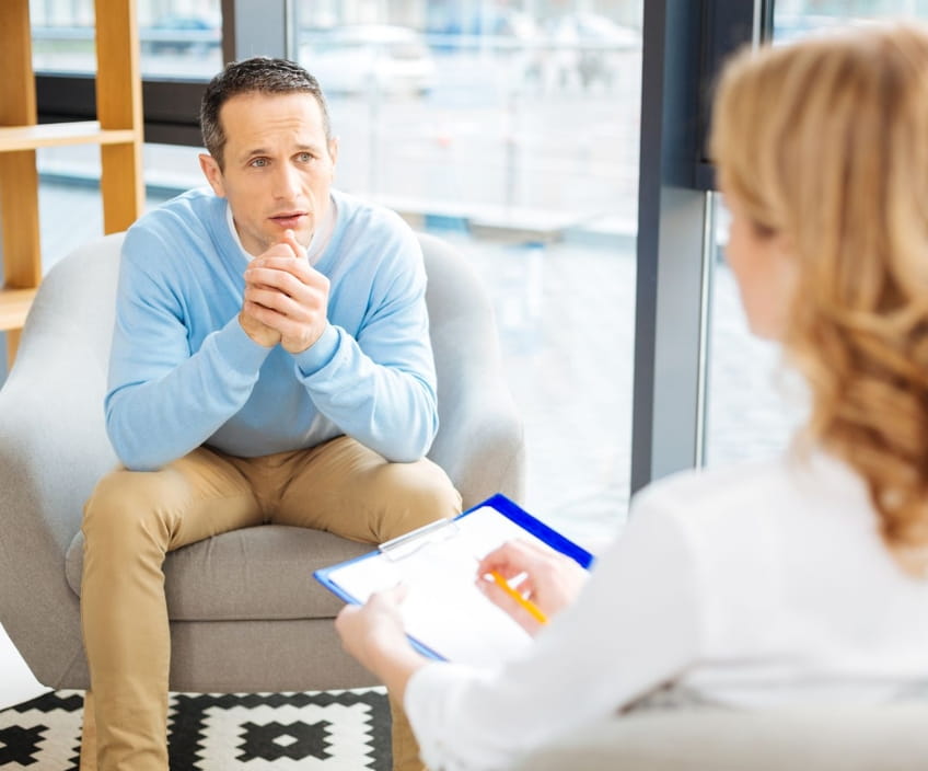 Man speaking with a therapist at a first consultation