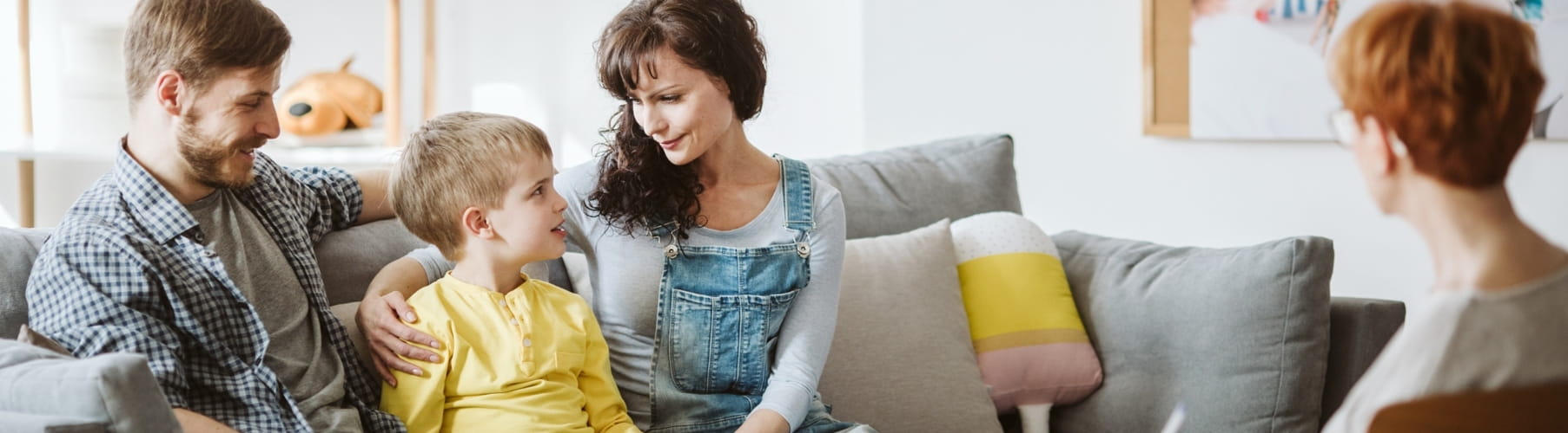 Parents and their young son talking with a therapist during a family therapy session in Vaughan