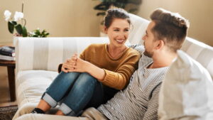Happy couple having a calm, open conversation at home while building healthy relationship boundaries