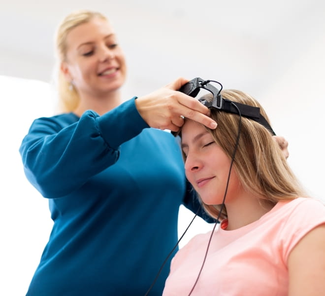 Clinician fitting an EEG biofeedback headband