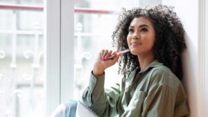 Woman daydreaming and thinking, illustrating inattentive ADHD