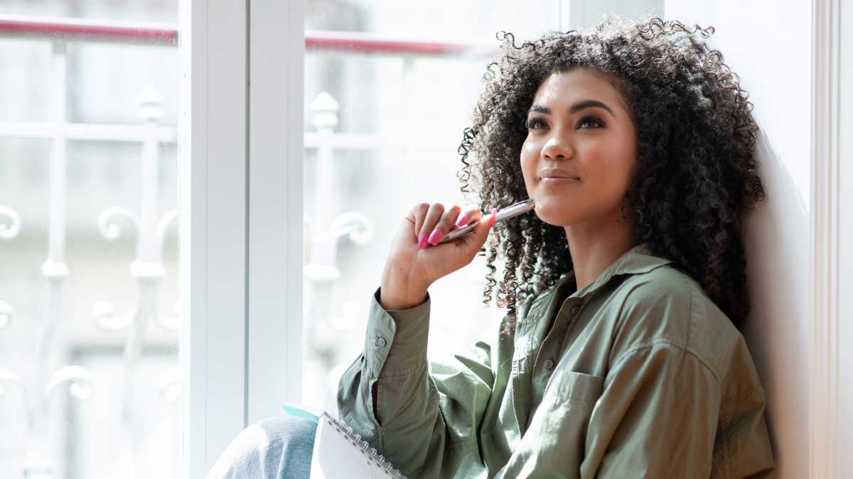 Woman daydreaming and thinking, illustrating inattentive ADHD