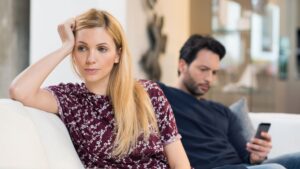 Woman experiencing relationship OCD and intrusive doubts while sitting next to her partner