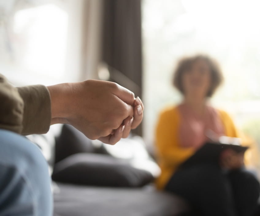 Client with clasped hands at a therapy session in Vaughan