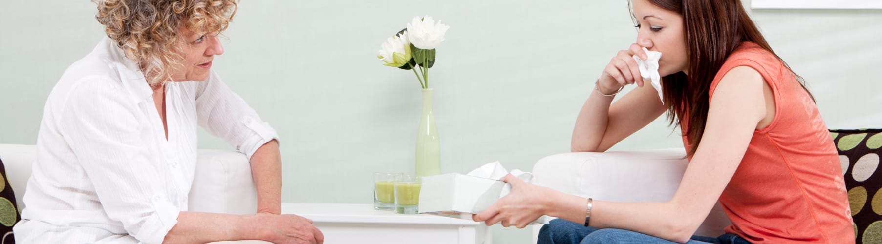 Grief counselling session in Vaughan, therapist passing tissues to a woman after a loss