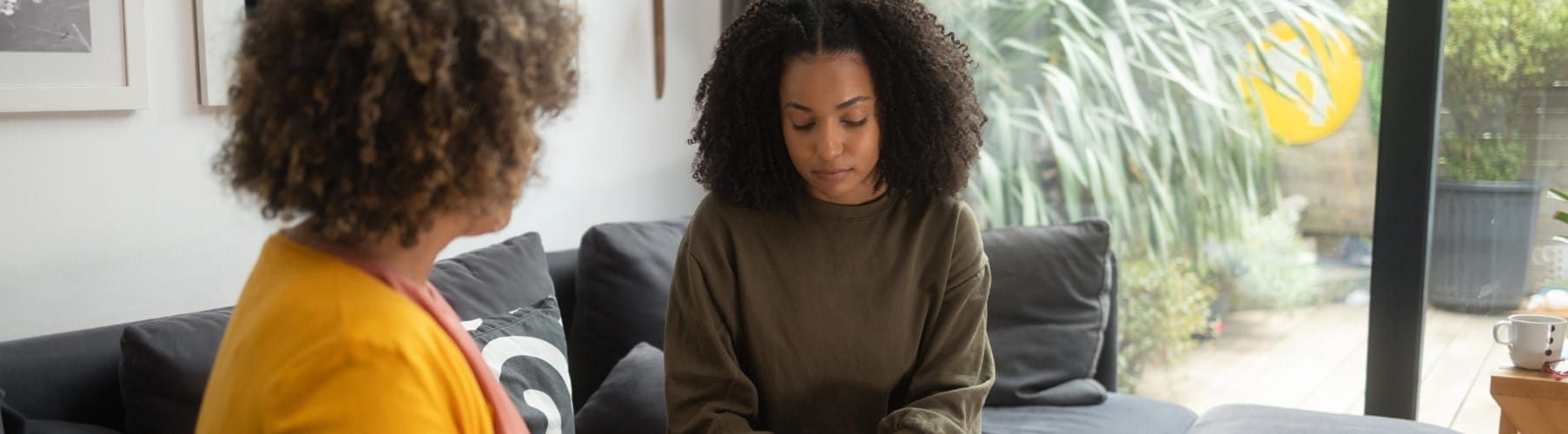 Therapist and client talking on a sofa
