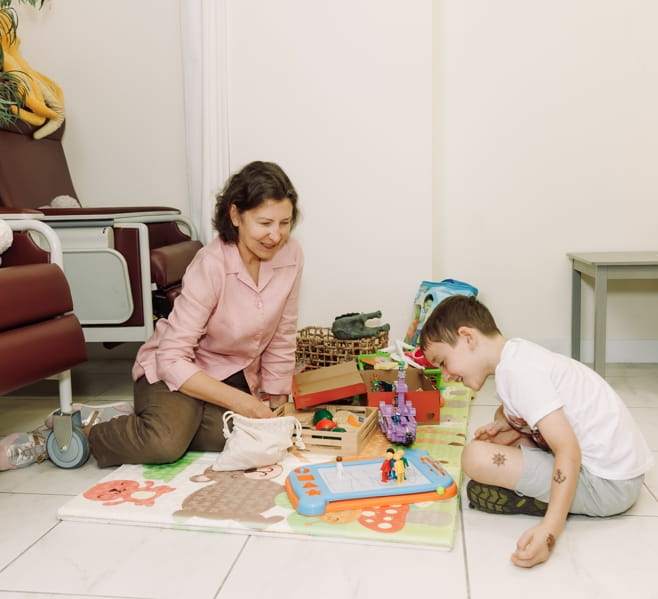 Therapist and young boy using toys during child therapy for North York and Toronto families