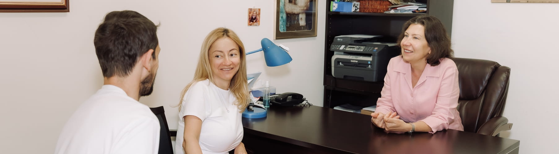 Two clients talking with a therapist during a life transitions therapy session in Vaughan