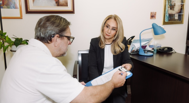 Senior man filling out intake forms with a registered psychotherapist in Vaughan