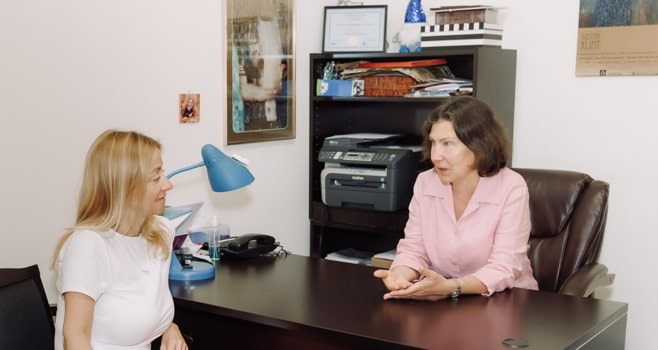 Registered psychotherapist explaining how cognitive behavioural therapy works to a client